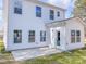 A view of the exterior backyard featuring vinyl siding, windows, and a concrete patio at 452 Duncan Creek Rd # 156, Lillington, NC 27546