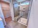 Walk-in tiled shower with a built-in bench and glass door plus an adjacent walk in closet at 452 Duncan Creek Rd # 156, Lillington, NC 27546