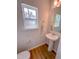 Bathroom featuring pedestal sink, wood-look flooring, and natural light at 452 Duncan Creek Rd # 156, Lillington, NC 27546