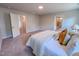 Bright bedroom featuring neutral walls, carpeted floors, and a bed with decorative pillows at 452 Duncan Creek Rd # 156, Lillington, NC 27546