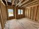 Unfinished bedroom with exposed studs, subfloor, and natural light through windows at 452 Duncan Creek Rd # 156, Lillington, NC 27546