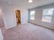 Bedroom featuring neutral walls, carpeted floors, two windows and an ensuite bathroom at 452 Duncan Creek Rd # 156, Lillington, NC 27546