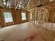 Unfinished bedroom featuring wood-framed walls, window views, and natural light at 452 Duncan Creek Rd # 156, Lillington, NC 27546