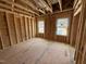 Spacious unfinished bedroom with exposed framing, subfloor, and window views at 452 Duncan Creek Rd # 156, Lillington, NC 27546
