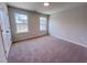 Bedroom featuring neutral walls, carpeted floors, and two large windows at 452 Duncan Creek Rd # 156, Lillington, NC 27546