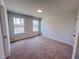 Bedroom featuring neutral walls, carpeted floors, and two large windows at 452 Duncan Creek Rd # 156, Lillington, NC 27546