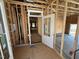 Unfinished entryway featuring a partially installed front door and stud walls at 452 Duncan Creek Rd # 156, Lillington, NC 27546
