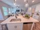 The kitchen features a stainless steel sink, dishwasher, a center island, and hardwood floors at 452 Duncan Creek Rd # 156, Lillington, NC 27546