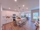 Modern kitchen with island, white cabinets, stainless steel appliances, and hardwood floors at 452 Duncan Creek Rd # 156, Lillington, NC 27546