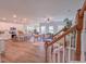 Open-concept living space with kitchen island, hardwood floors, and staircase at 452 Duncan Creek Rd # 156, Lillington, NC 27546
