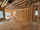 Open-concept living room in the stud-framing stage, revealing layout and window placements at 452 Duncan Creek Rd # 156, Lillington, NC 27546