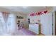 This bedroom is brightly lit with an abundance of furniture including a dresser, bookcase and hanging wall art at 507 Southwick Pl, Mebane, NC 27302