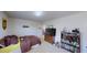 Bedroom featuring carpet and a TV and shelf with a collection of toys and books at 507 Southwick Pl, Mebane, NC 27302