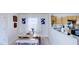 Bright dining area features a rustic table, white bench seating and modern artwork at 507 Southwick Pl, Mebane, NC 27302