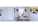 Bright dining area features a rustic table, white bench seating and modern artwork at 507 Southwick Pl, Mebane, NC 27302