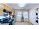 Well-lit kitchen featuring wood cabinets, black appliances, and access to the back door at 507 Southwick Pl, Mebane, NC 27302