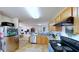 Spacious kitchen that opens to the living room, featuring wood cabinets and stainless steel appliances at 507 Southwick Pl, Mebane, NC 27302
