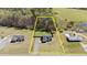 Aerial view of property showcasing lot size, landscaping, and proximity to woods at 511 Mcarthur Rd, Broadway, NC 27505