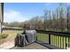 Back deck of the home with view of the tree line and a grill at 511 Mcarthur Rd, Broadway, NC 27505