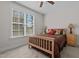 Cozy bedroom with carpet, ceiling fan, natural light from window, and stylish furnishings at 511 Mcarthur Rd, Broadway, NC 27505