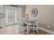 Cozy dining area near kitchen features a white table with seating for four and a view to the backyard at 511 Mcarthur Rd, Broadway, NC 27505