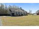 Spacious home with attached garage, showcasing ample parking and neutral siding at 511 Mcarthur Rd, Broadway, NC 27505