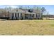 Well-maintained home featuring black shutters, manicured landscaping, and cozy front porch at 511 Mcarthur Rd, Broadway, NC 27505