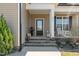 Charming front entrance with stone steps and black front door at 511 Mcarthur Rd, Broadway, NC 27505
