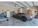 Spacious garage with high ceilings featuring an impressive gray sports car and ample storage at 511 Mcarthur Rd, Broadway, NC 27505