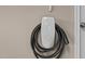 Close-up of a wall-mounted Tesla electric vehicle charger in the garage at 511 Mcarthur Rd, Broadway, NC 27505