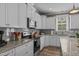 Well-lit kitchen with white cabinets, granite countertops, stainless appliances, and subway tile backsplash at 511 Mcarthur Rd, Broadway, NC 27505