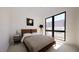 Bright bedroom with a queen-size bed, large windows, and simple decor at 512 Gordon St # 404, Durham, NC 27701