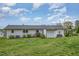 Spacious backyard featuring lush lawn, outbuildings, and a charming patio area at 5121 Leesville Rd, Durham, NC 27703