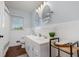 Bathroom showcasing a double sink vanity, tiled walls, updated mirrors, and natural light from the window at 5121 Leesville Rd, Durham, NC 27703