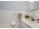 Bathroom featuring a white vanity, tiled walls, decorative accents, and a clean, well-maintained space at 5121 Leesville Rd, Durham, NC 27703