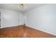 Bedroom featuring hardwood floors, neutral paint, a modern light fixture, and access to a walk-in closet at 5121 Leesville Rd, Durham, NC 27703