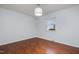Bedroom featuring hardwood floors, a large window with blinds, and neutral paint, creating a serene atmosphere at 5121 Leesville Rd, Durham, NC 27703