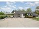 Exterior shot of a house featuring white brick and siding, carport, and a large driveway at 5121 Leesville Rd, Durham, NC 27703