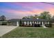 Inviting home exterior with manicured lawn, colorful landscaping, and covered parking at 5121 Leesville Rd, Durham, NC 27703