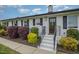 Charming front entrance with painted stairs, manicured bushes, and a decorative door wreath at 5121 Leesville Rd, Durham, NC 27703