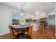 Cozy kitchen with white cabinets and stainless steel appliances open to the dining area at 5121 Leesville Rd, Durham, NC 27703