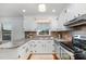 Bright kitchen with white cabinets, stainless steel appliances, and a window over the sink at 5121 Leesville Rd, Durham, NC 27703