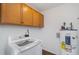 Laundry room with modern appliances, ample cabinet space, and durable flooring for convenient chores at 5121 Leesville Rd, Durham, NC 27703
