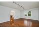 Empty living room with hardwood floors, light blue walls, and lots of natural light at 5121 Leesville Rd, Durham, NC 27703