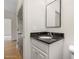 Neat bathroom with granite countertop, white vanity with brushed nickel hardware and framed mirror at 55 Glasgow, Rocky Mount, NC 27804