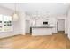 Bright kitchen with island, stainless appliances, stone countertops, pendant lighting, and hardwood floors at 55 Glasgow, Rocky Mount, NC 27804