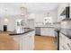 Bright kitchen featuring an island, stainless steel appliances, granite countertops, and white cabinetry at 55 Glasgow, Rocky Mount, NC 27804