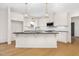 Spacious kitchen featuring an island, granite countertops, stainless steel appliances, and decorative pendant lights at 55 Glasgow, Rocky Mount, NC 27804
