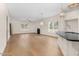 Open-concept living room with hardwood floors, modern lighting, and large windows offering natural light at 55 Glasgow, Rocky Mount, NC 27804