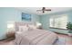 Light-filled bedroom features a neutral color scheme, ceiling fan and modern furnishings at 5932 Whitebud Dr, Raleigh, NC 27609